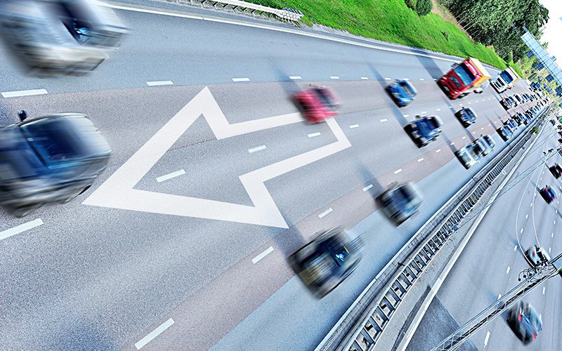 Aerial view of fast moving traffic on a highway.