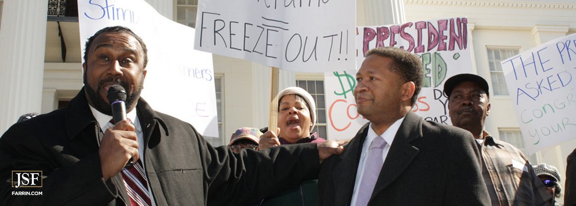 John Boyd, Jr., standing next to former Congressman Artur Davis, delivering a speech at a rally for Black farmers in Alabama.