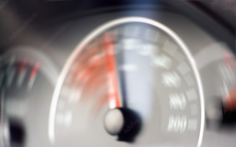 Blurred speedometer rising quickly from unintended acceleration.
