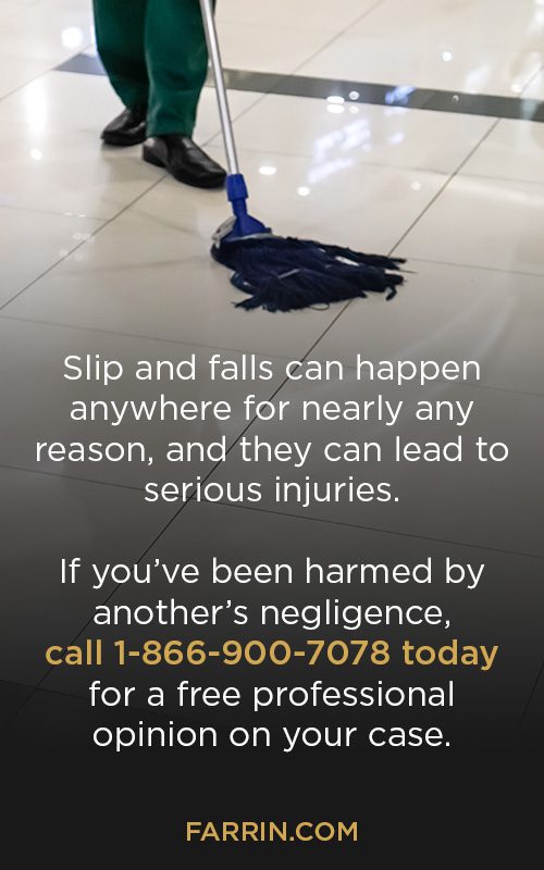A worker mopping a tile floor, creating a potentially hazardous environment.